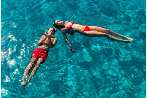 Couple floating in the clear shallow water at Blue Lagoon near Ayia Napa