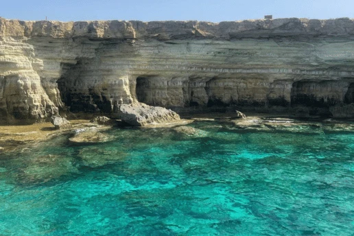 Crystal-clear turquoise water inside a sea cave at Cape Greco, Cyprus