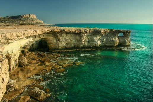 Limestone cliffs and a sea cave at the Ayia Napa Sea Caves, Cape Greco, in late afternoon light