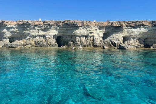 imestone cliffs and sea caves along the Cape Greco coastline near Ayia Napa, seen from the water