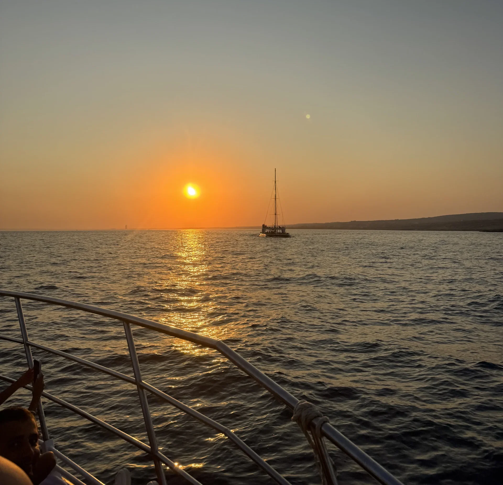 Catamaran anchored on the open sea at sunset off the Ayia Napa coast
