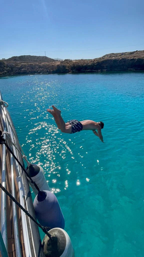 Guest diving from the boat into clear turquoise water on an Ayia Napa Blue Lagoon cruise