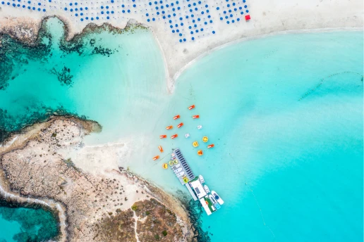 Aerial view of Nissi Beach, its sandbar islet and water sports area in Ayia Napa, Cyprus